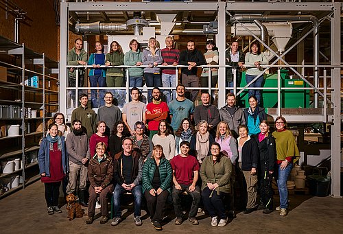 ReinSaat Team 2024 - Gruppenbild flankiert von Gewächshäusern